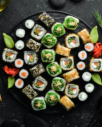 set-traditional-sushi-black-plate-sushi-rolls-dark-background-scaled (1)