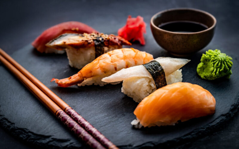 tasty-sushi-sashimi-set-composition-with-shrimps-ginger-soy-sauce-served-with-chopsticks-gre-2